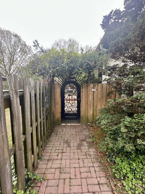 Arched garden gate · scrollwork & vine