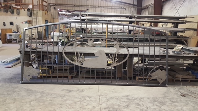 Custom drive gate · waterfowl & cattail medallion
