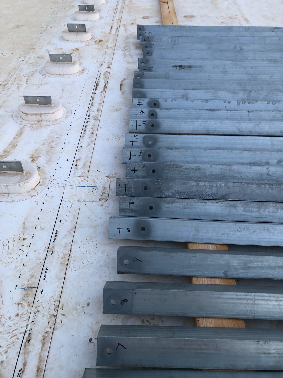 Galvanized T-brackets laid out on a roof deck